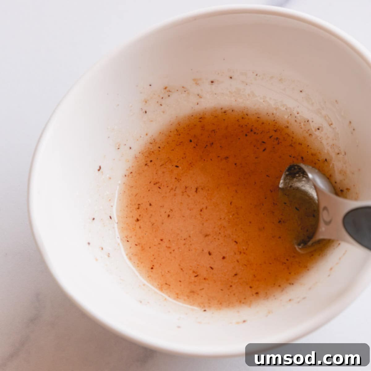 Blueberry Cheesecake Swirl Muffins 4 Sugar glaze in a white bowl ready for use.
