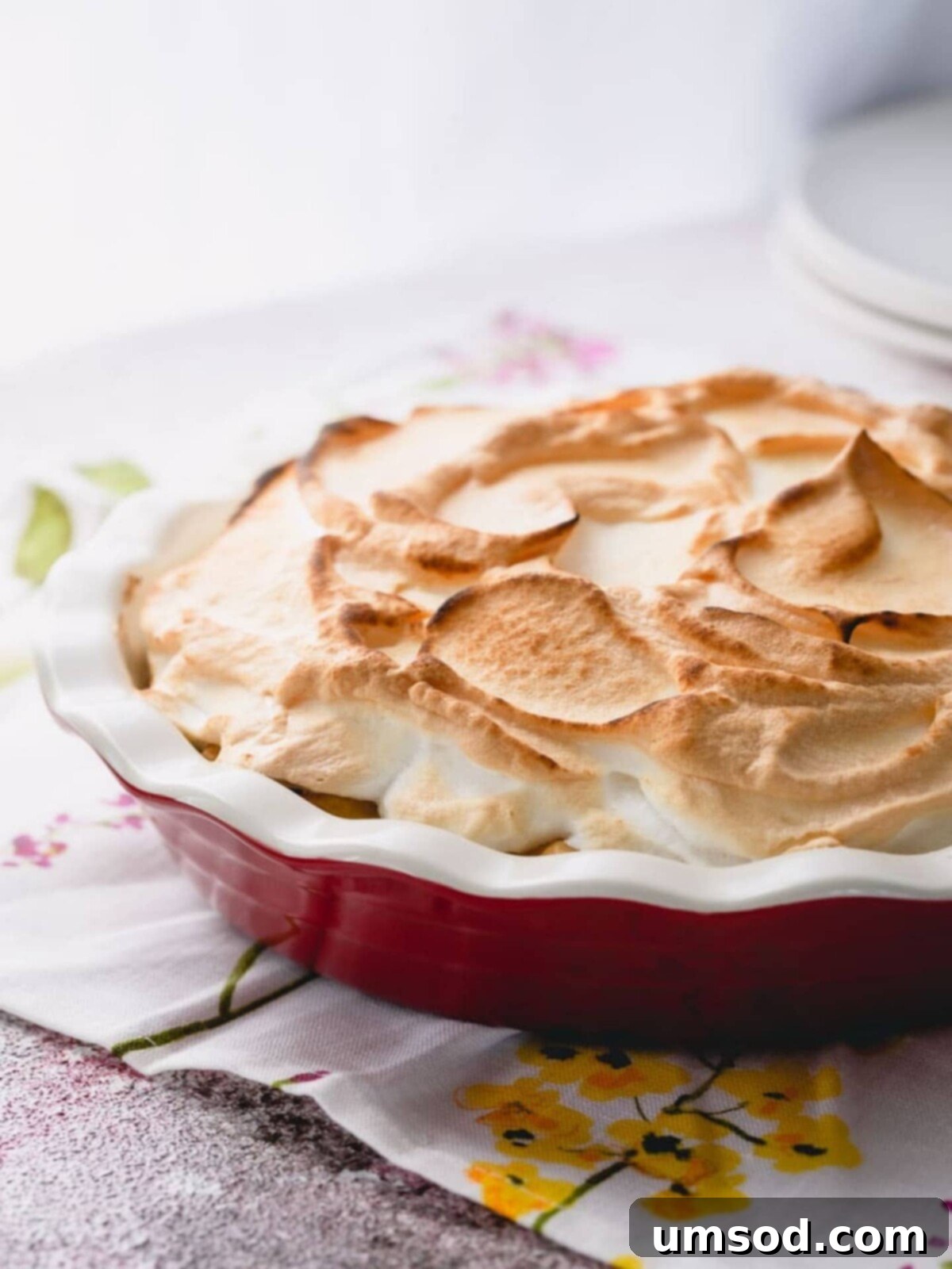 Zesty Lemon Cloud Pie 3 A stunning lemon meringue pie baked to perfection in a classic pie dish.
