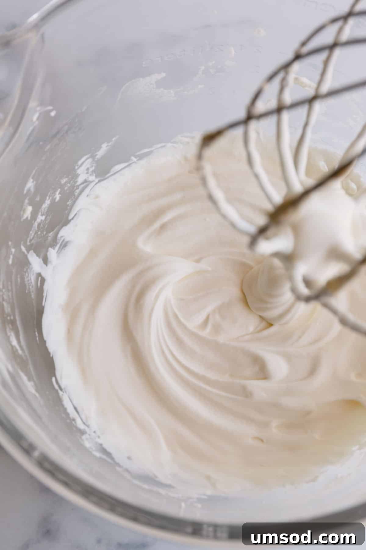 A generous serving of light and airy homemade yogurt whipped cream, showcasing its perfect, cloud-like texture.