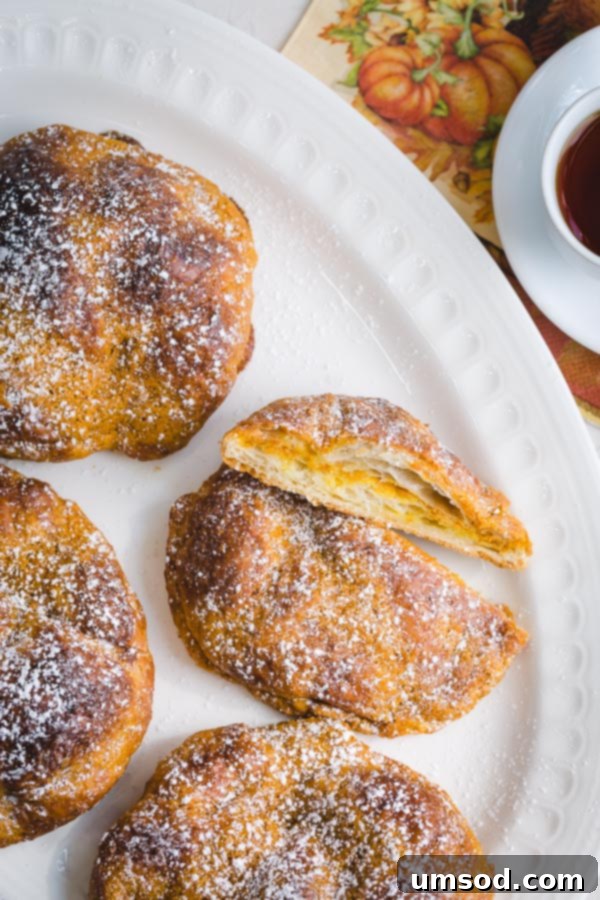 Delicious pumpkin croissants with a crispy exterior and soft, custardy pumpkin filling. Quick and easy fall recipe. #pumpkineverything #pumpkindessert #pumpkincroissant