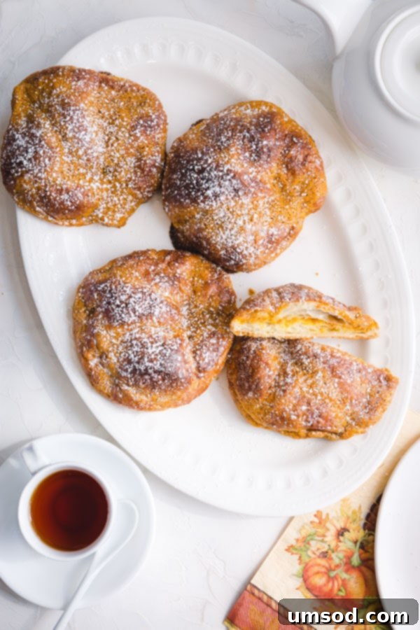 A basket of freshly baked pumpkin croissants, perfect for fall brunches and gatherings. Easy, quick, and delicious. #pumpkineverything #pumpkindessert #pumpkincroissant