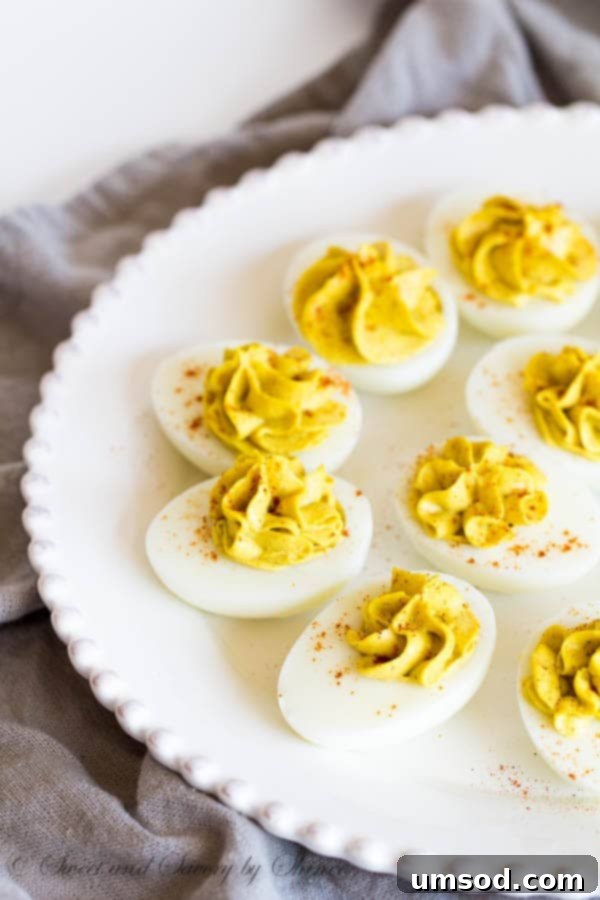 Golden Curry Deviled Eggs 2 Beautifully garnished Curry Deviled Eggs ready to serve, showcasing their vibrant color and creamy texture.