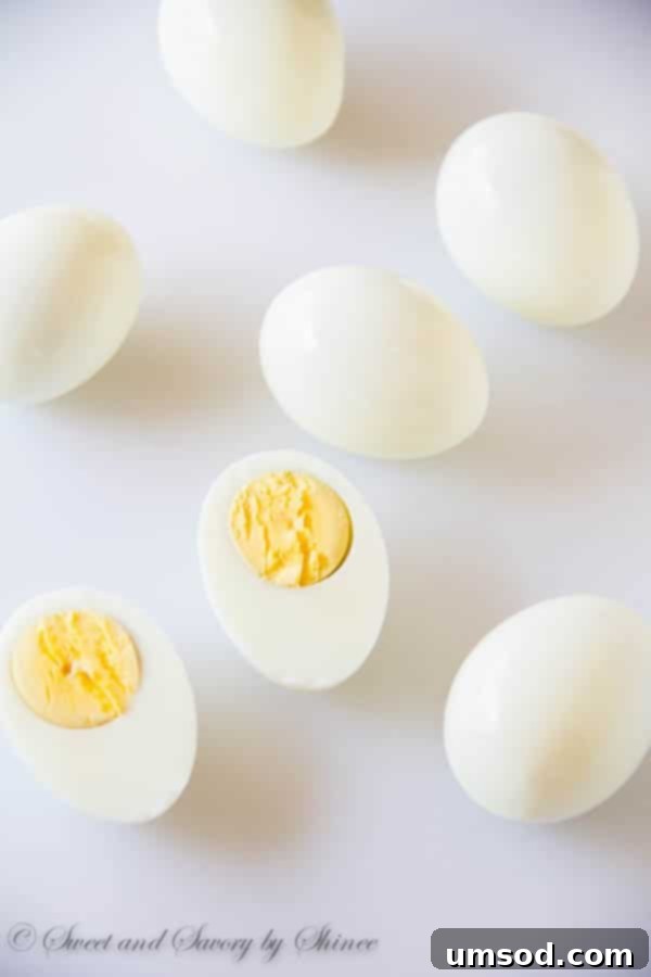 Golden Curry Deviled Eggs 3 A close-up shot of perfectly steamed hard-boiled eggs, ready for peeling.