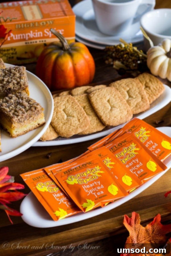 A warm cup of pumpkin spice tea nestled among vibrant fall leaves, inviting relaxation and autumn comfort.