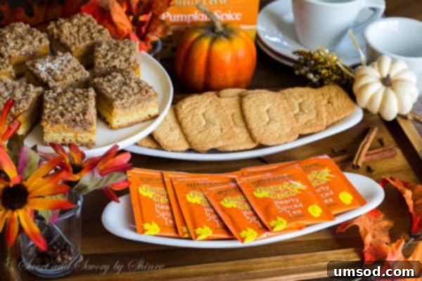 Close-up of a cup of Bigelow Pumpkin Spice tea with delectable pumpkin streusel bars, ideal fall treats.