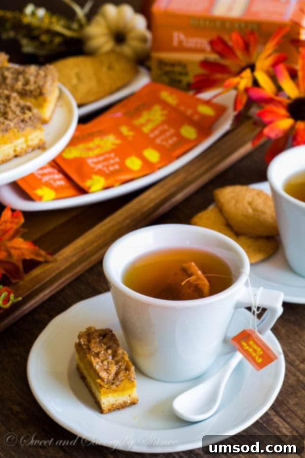 A warm and inviting living room scene, perfect for a fall tea party, featuring a cozy fireplace and autumnal decor.