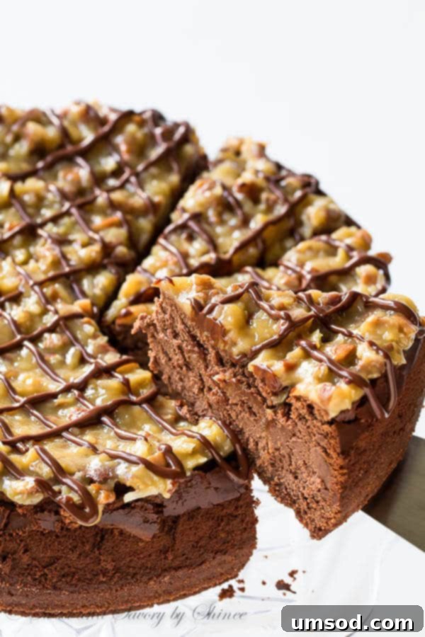 A full German chocolate cheesecake showing its tall, impressive layers, ready for slicing.