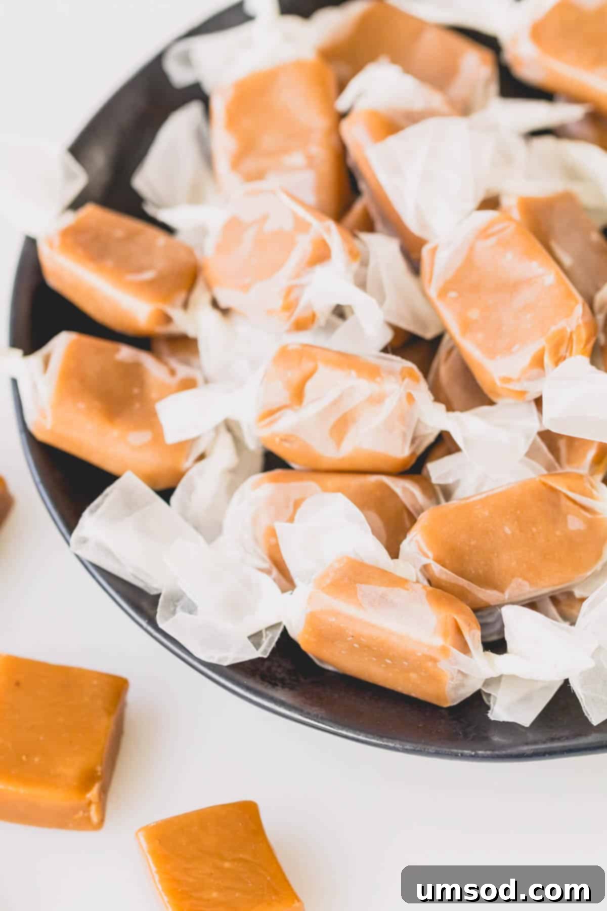 A bowl of wrapped cardamom caramel candies.