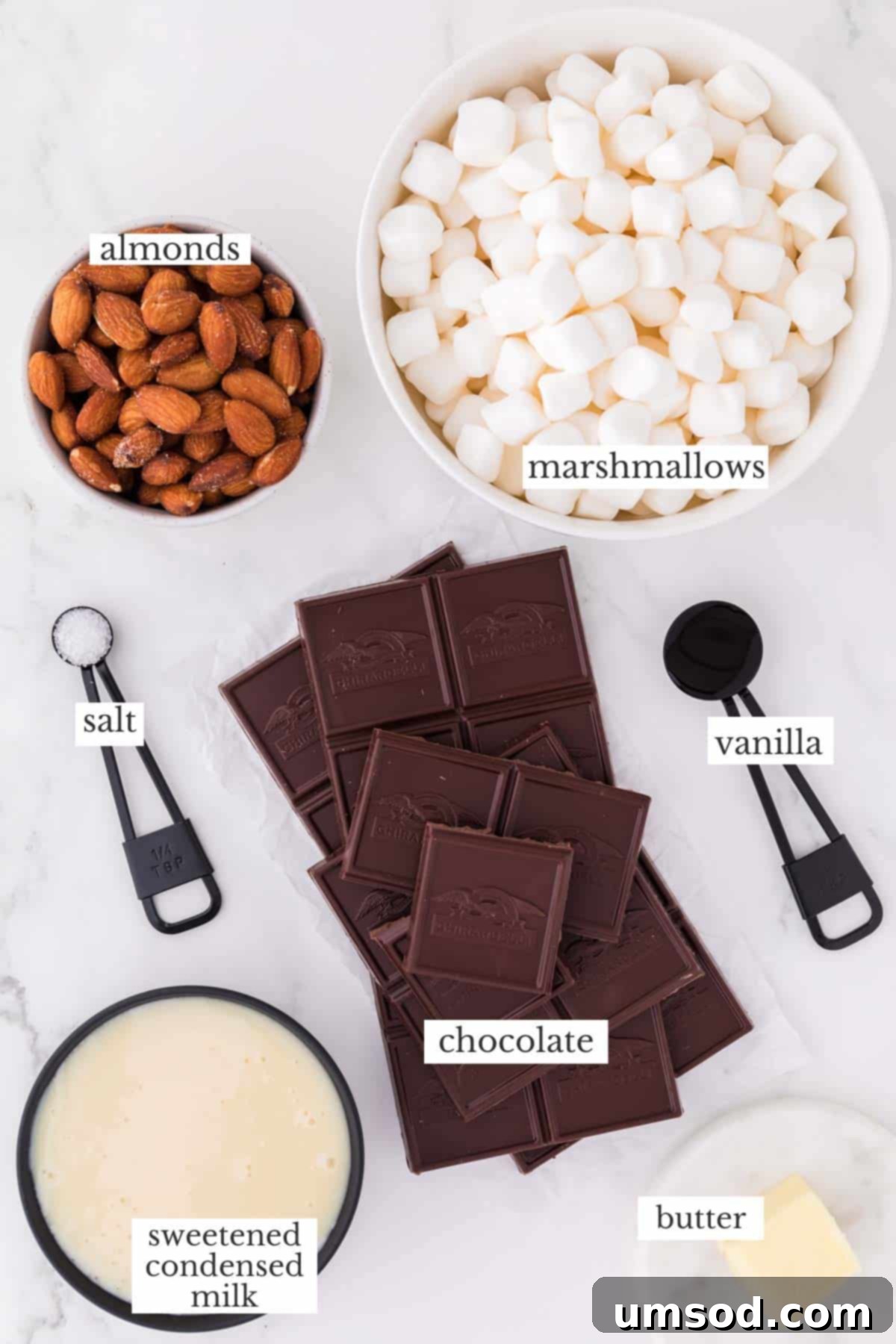 ingredients for rocky road fudge including chocolate, marshmallows, and almonds