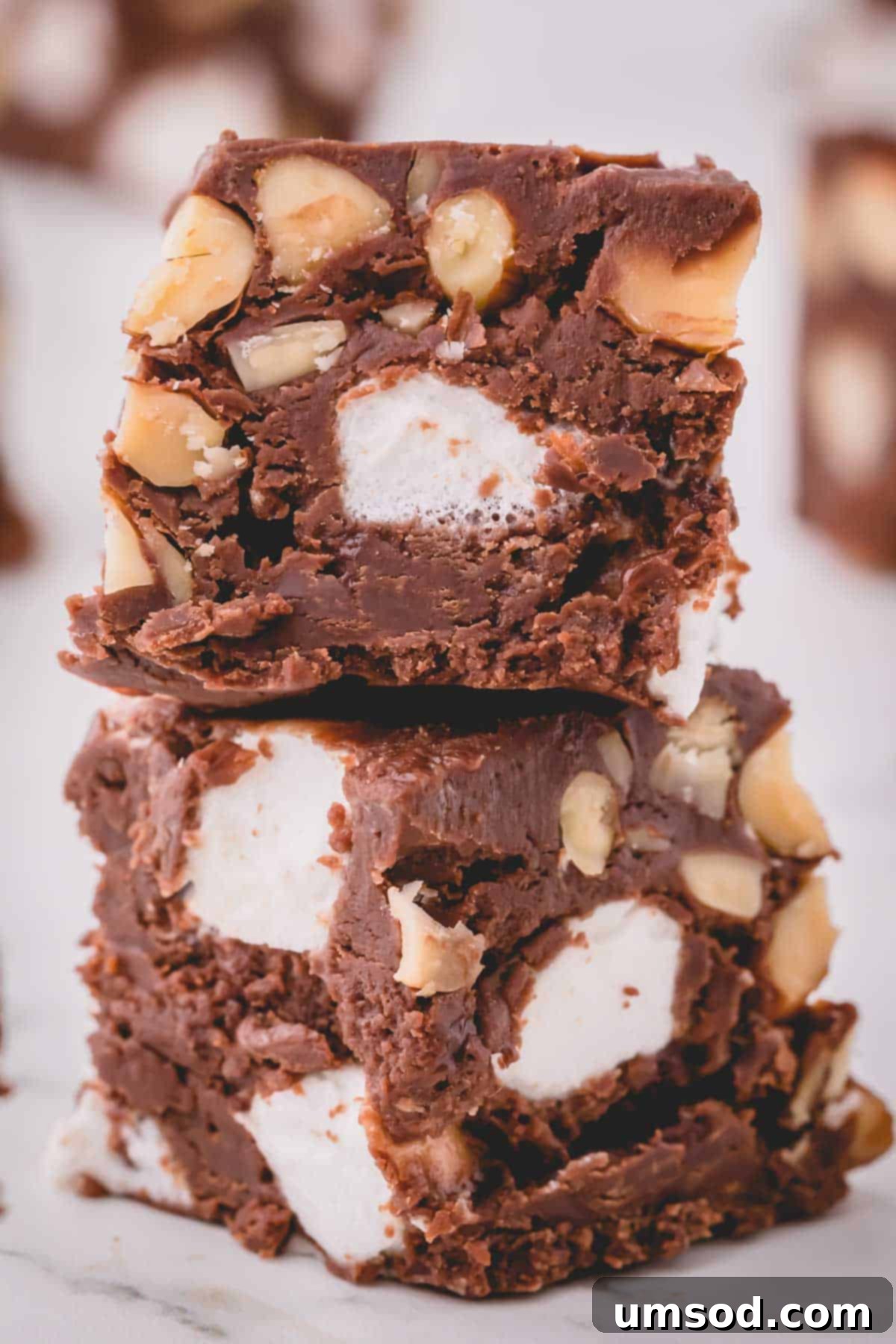 a stack of rocky road fudge pieces on a white plate