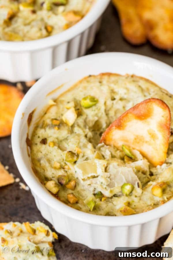 Five Ingredient Pesto Artichoke Dip 6 A selection of toasted bread and crackers served with a ramekin of warm Pesto Artichoke Dip.
