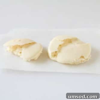 Decoding Macaron Dilemmas 8 Macaron shells with visible cracks on their surface.