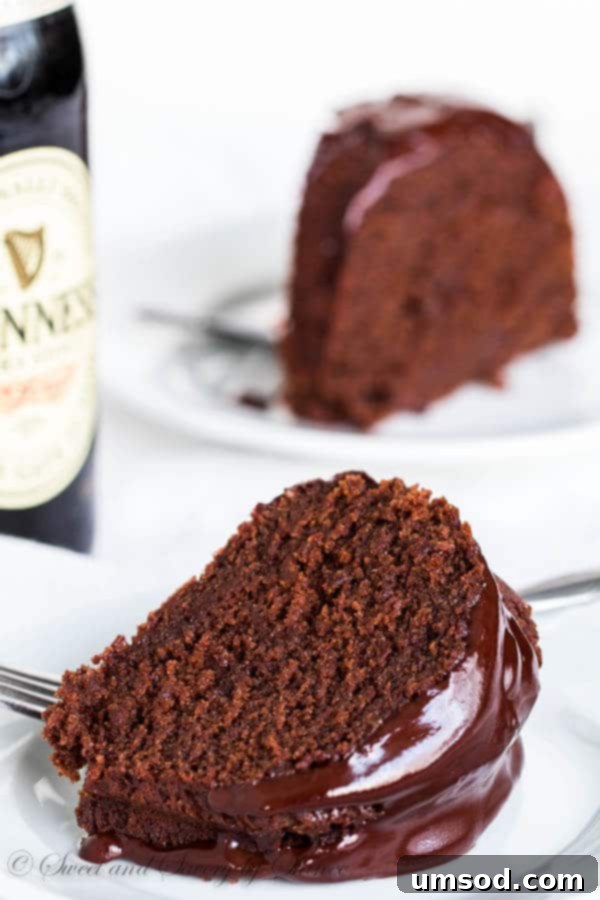 Close-up of a double stout chocolate bundt cake with stout ganache and slivered dark chocolate
