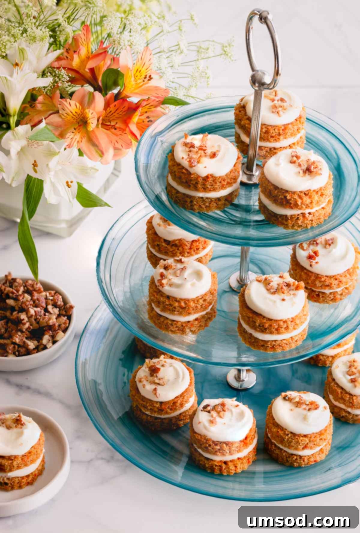 Perfectly Portioned Pecan-Topped Carrot Cakes 12 Mini carrot cakes elegantly displayed on a three-tier platter, ready for serving.