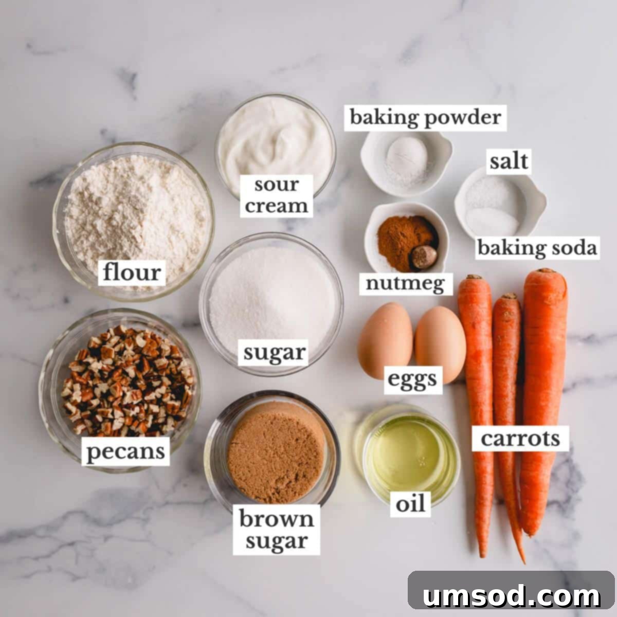 Perfectly Portioned Pecan-Topped Carrot Cakes 4 A collection of ingredients for carrot cake, including carrots, flour, spices, and eggs.