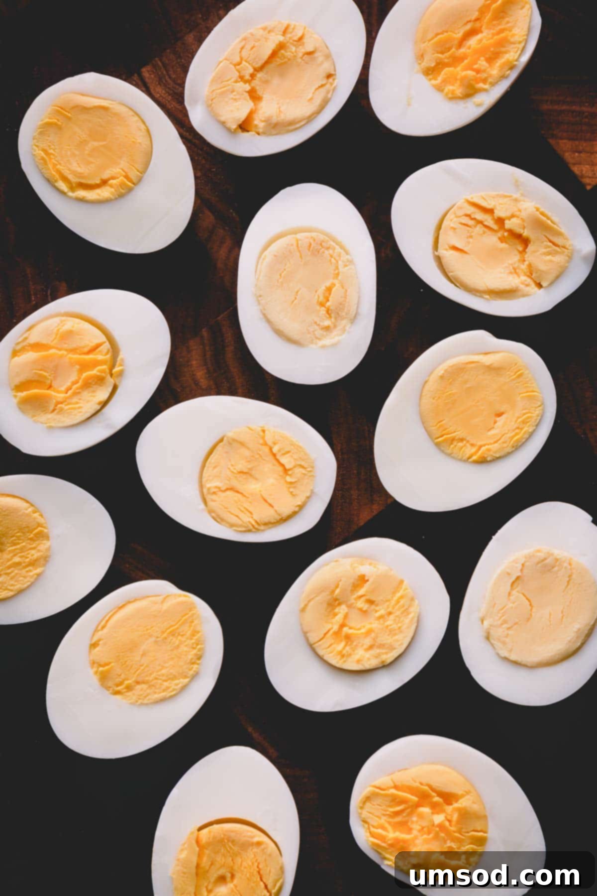 Halved perfect hard-boiled eggs on a cutting board, ready to be enjoyed.