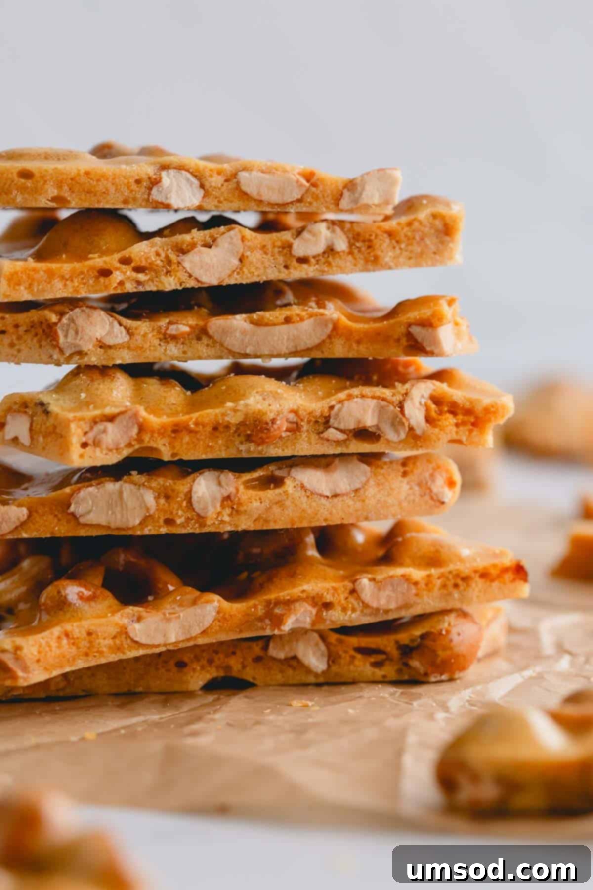 Effortless Microwave Peanut Brittle 10 A beautifully stacked collection of homemade peanut brittle pieces, highlighting their golden color and inviting texture.