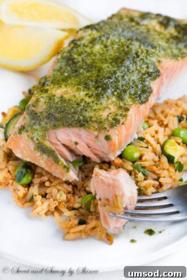 Unlock the Secret to Perfect Baked Salmon 3 Close-up of baked salmon fillets with pesto, showcasing their tender texture.