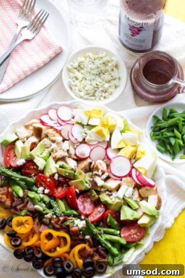 Close-up of a refreshing Spring Cobb Salad showcasing the diverse textures and fresh ingredients, perfectly complemented by Marzetti® Vineyard Dressing.