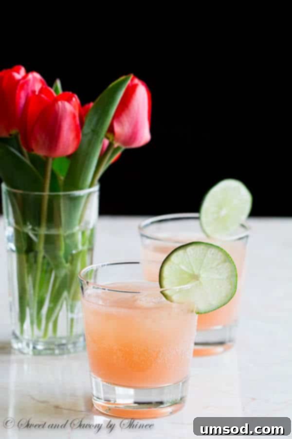 Vibrant Grapefruit Paloma 3 Close-up of a refreshing Grapefruit Paloma cocktail garnished with lime, ready for enjoyment.