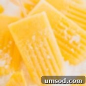 Another appealing shot of frozen pineapple popsicles, perfectly captured.