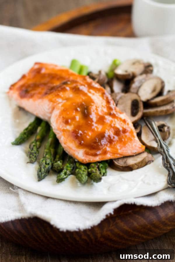Spicy apricot salmon with roasted asparagus and mushrooms - light and nutritious dinner bursting with flavor! All it takes is one sheet pan, five ingredients, and less than 30 minutes! Quick n' simple doesn't have to be bland.