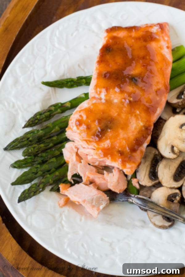 Spicy apricot salmon with roasted asparagus and mushrooms - light and nutritious dinner bursting with flavor! All it takes is one sheet pan, five ingredients, and less than 30 minutes! Quick n' simple doesn't have to be bland.