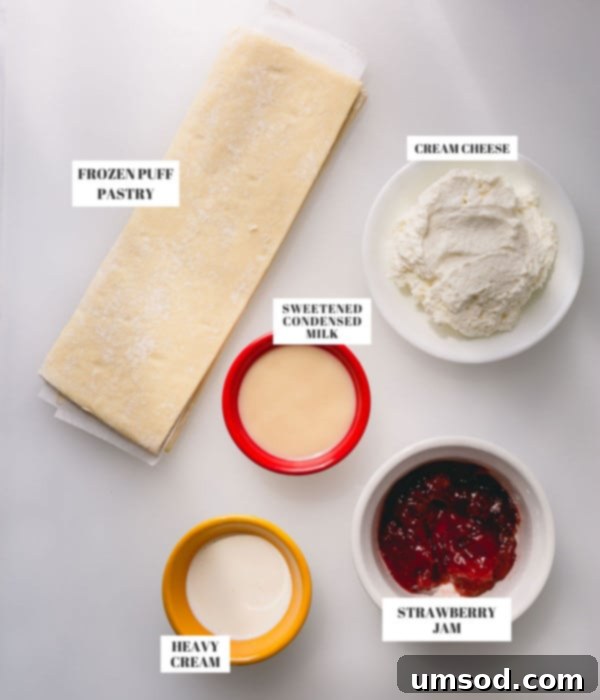Individual ingredients for the strawberry cheesecake tart, including puff pastry, cream cheese, jam, and condensed milk