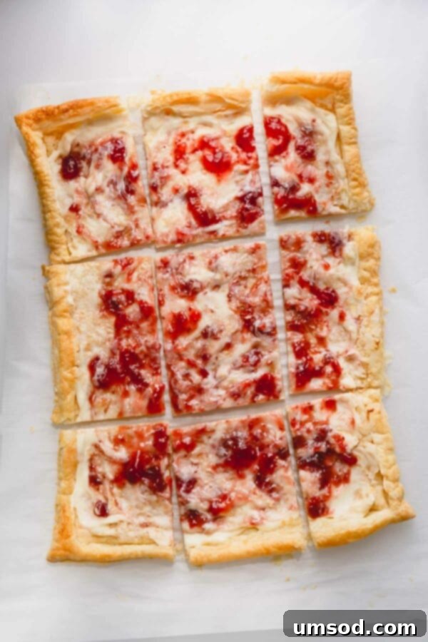 A freshly baked strawberry cheesecake tart, sliced and ready to serve