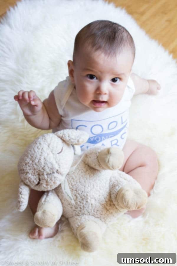 Baby Grant smiling brightly at 7 months, showcasing his rapid development and joy