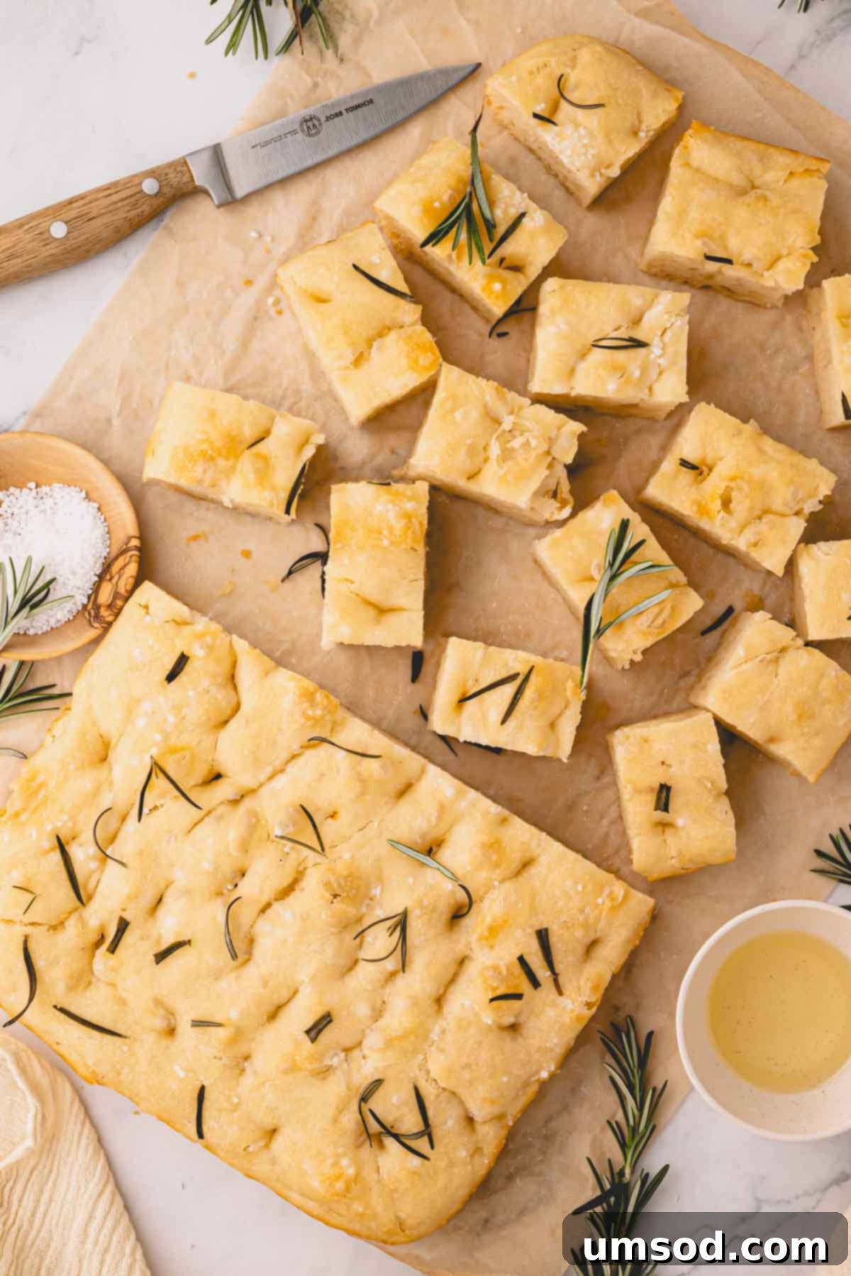 Effortless Homemade Focaccia: A Baker's Delight 2 Rosemary focaccia bread loaf sliced on parchment paper