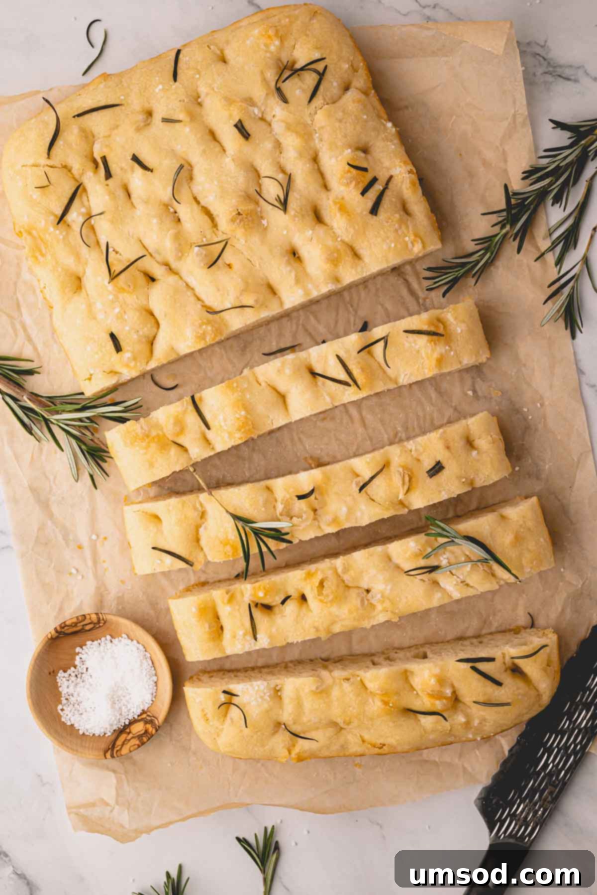 Effortless Homemade Focaccia: A Baker's Delight 17 Sliced rosemary focaccia bread on parchment paper