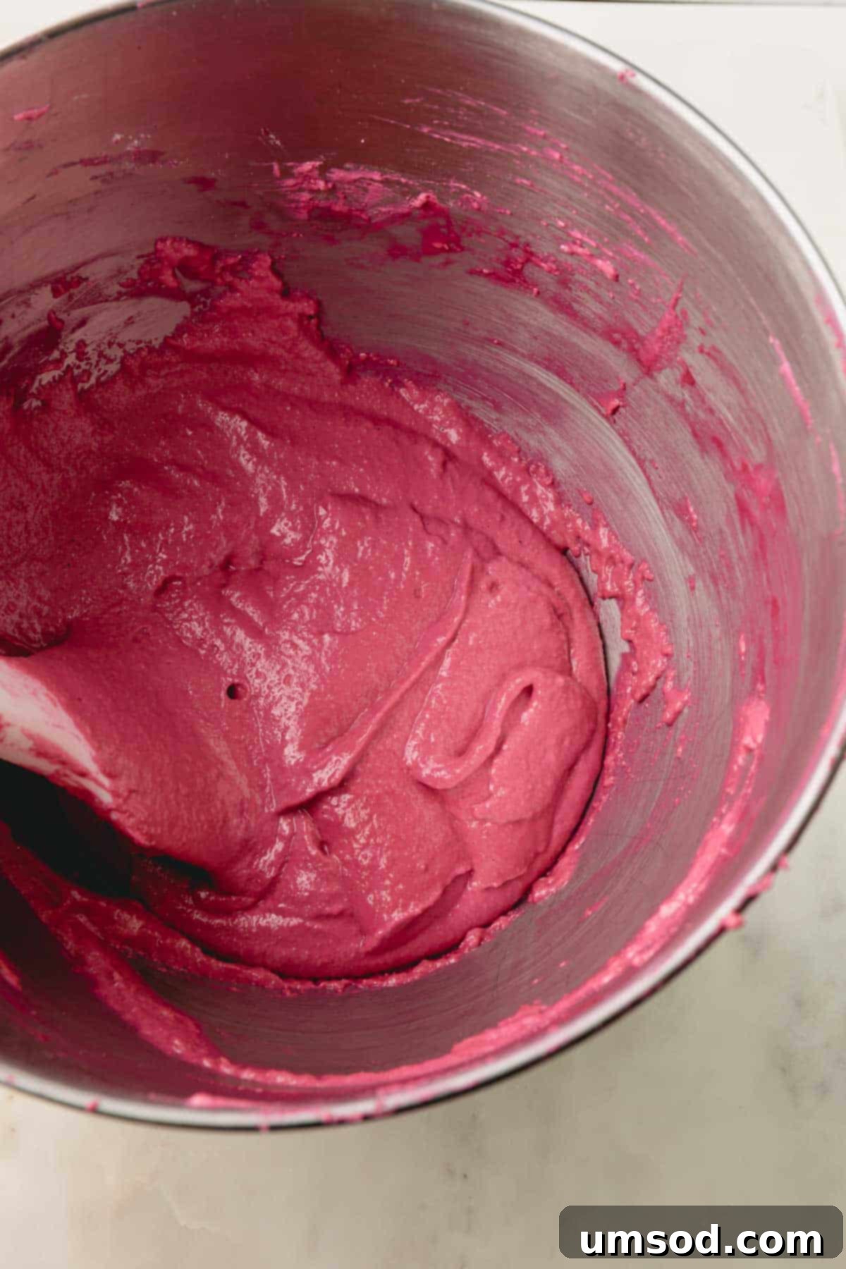 Cranberry Citrus Macarons 14 Another view of the cranberry macaron batter, highlighting its smooth and glossy texture.