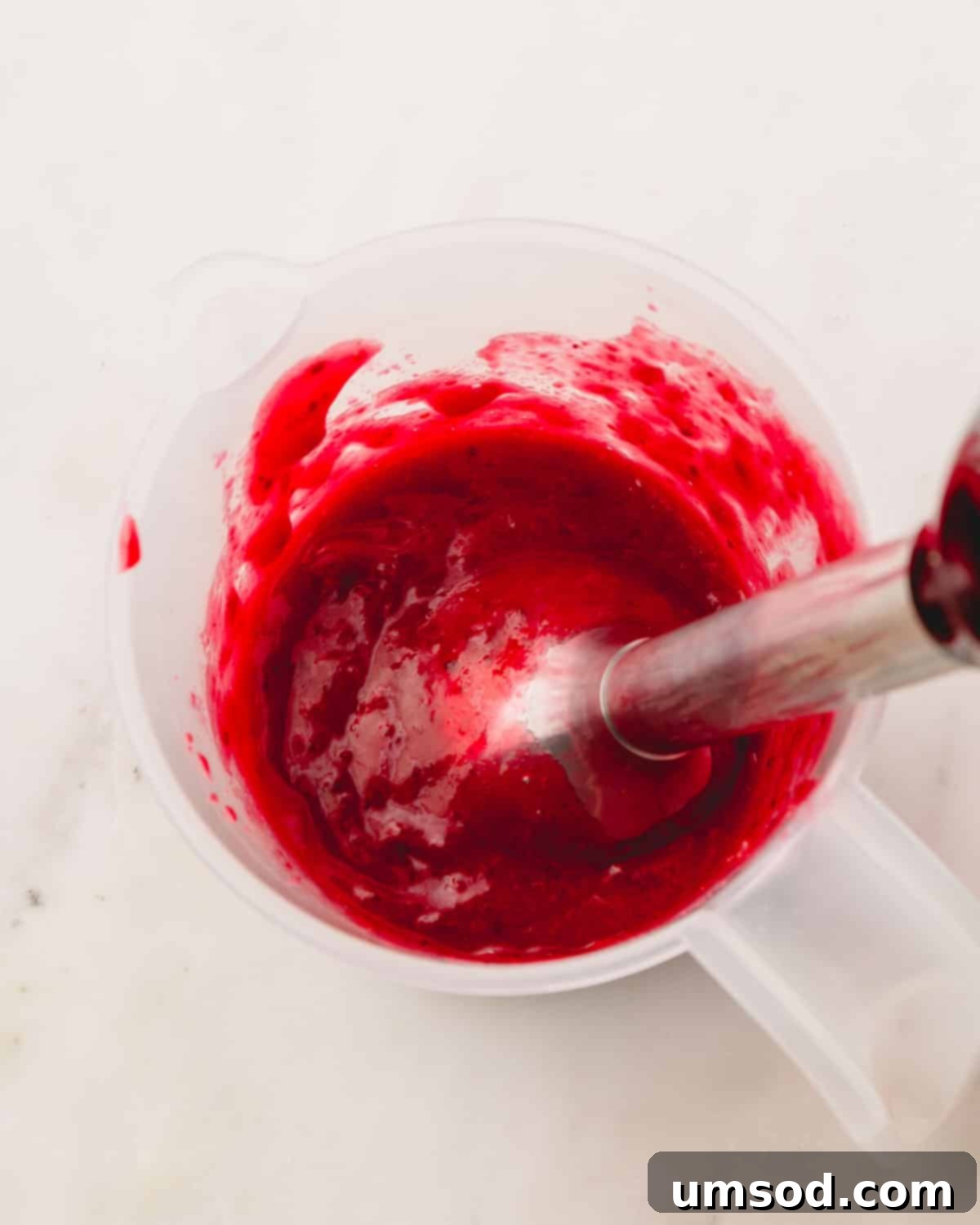 Cranberry Citrus Macarons 19 Fresh cranberries simmering in a saucepan with water, sugar, and spices.
