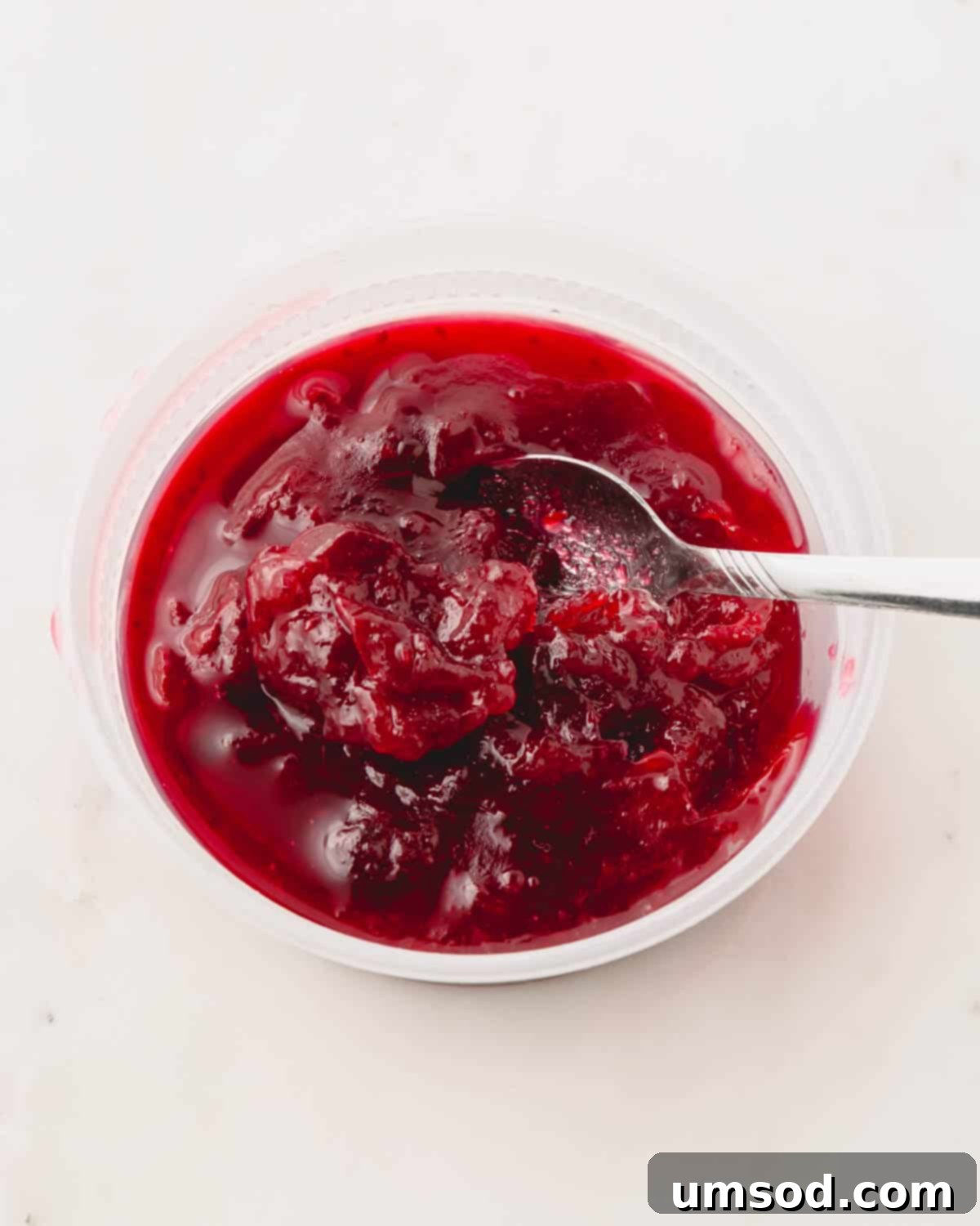 Cranberry Citrus Macarons 20 Close-up of the simmering cranberry sauce, showing its thickening consistency.